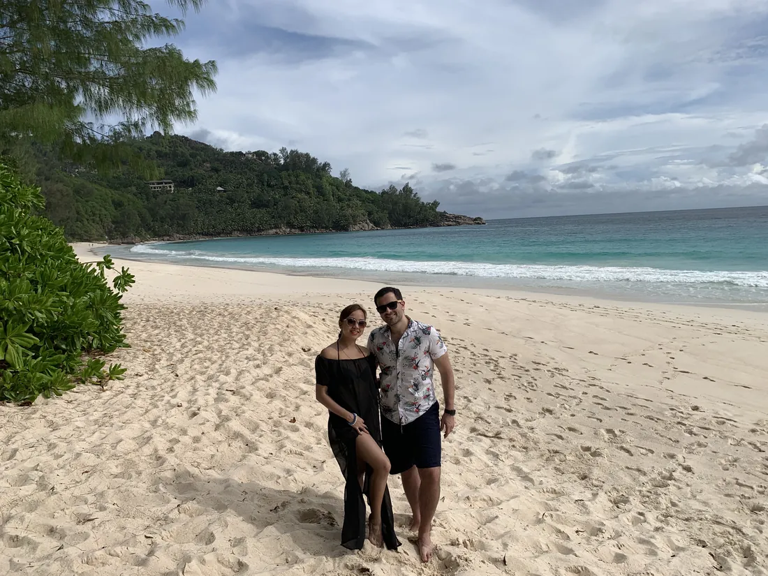 Dee and her husband on an empty Seychelles beach