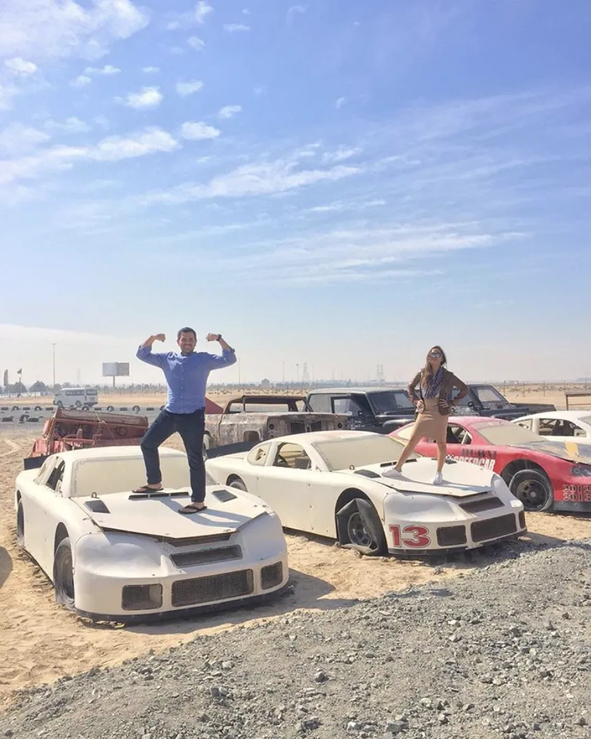 Striking a pose on the old race cars at Last Exit, on the road to Abu Dhabi.