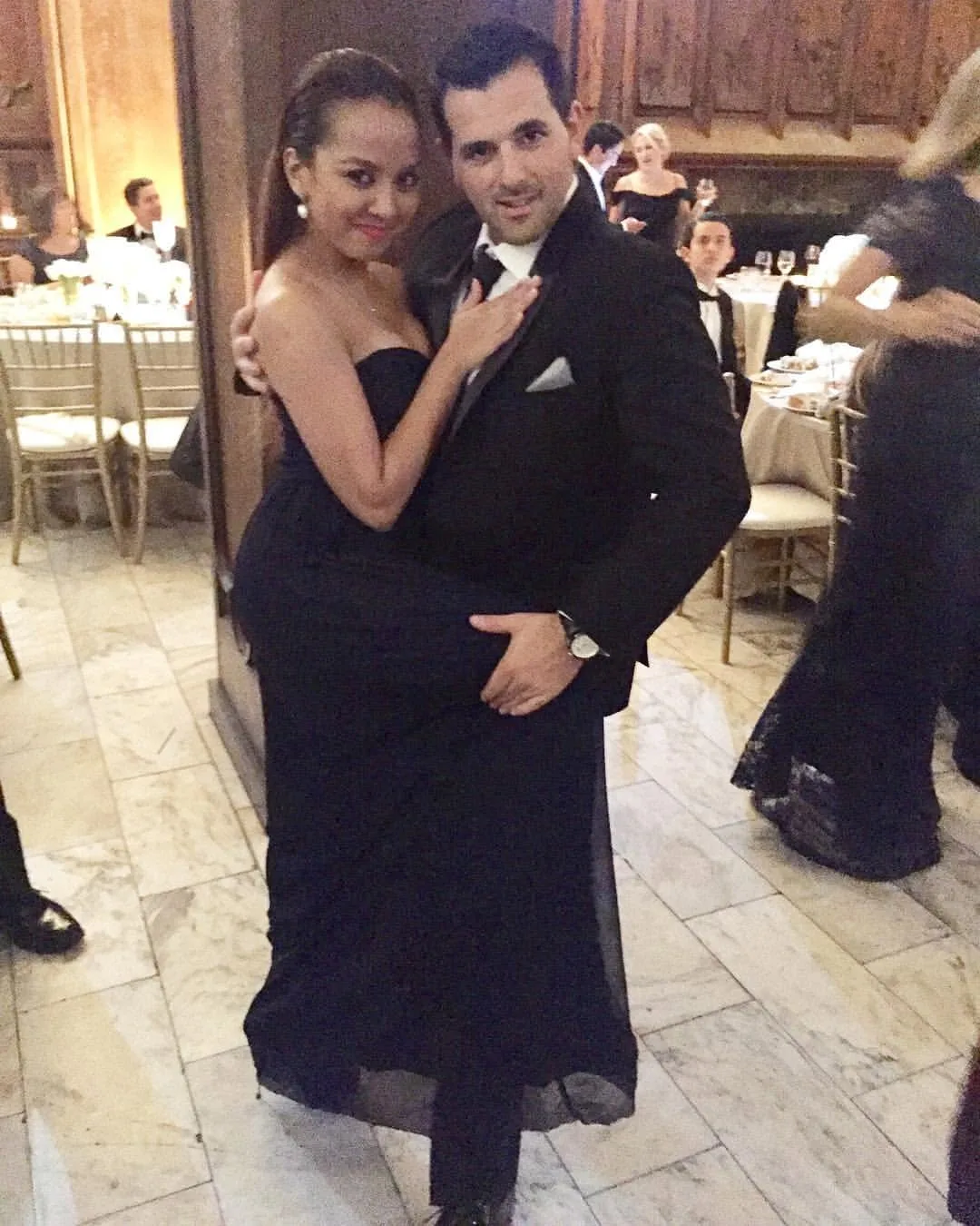 Dee and her husband in evening wear, posing in a dance hold