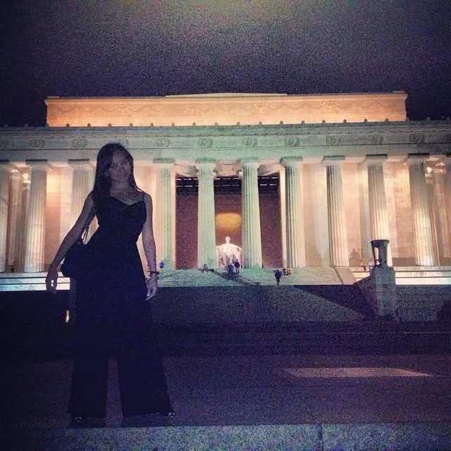 Dee at night in front of the lit-up Lincoln Memorial
