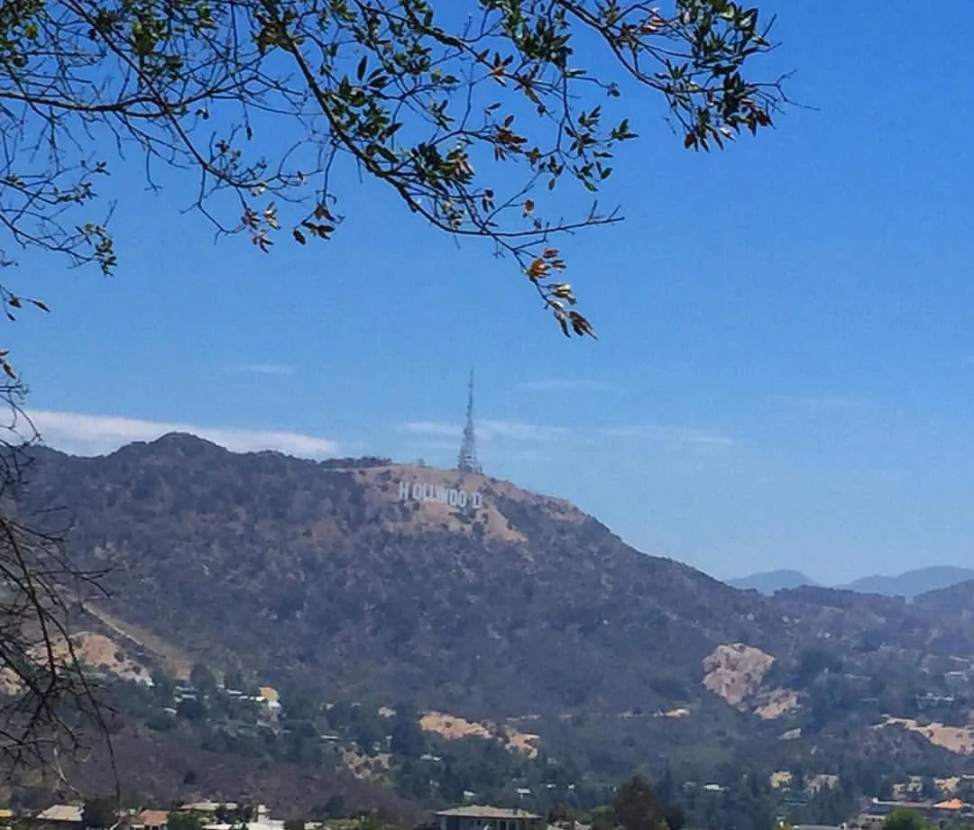 The Hollywood sign on the hills under a clear blue sky